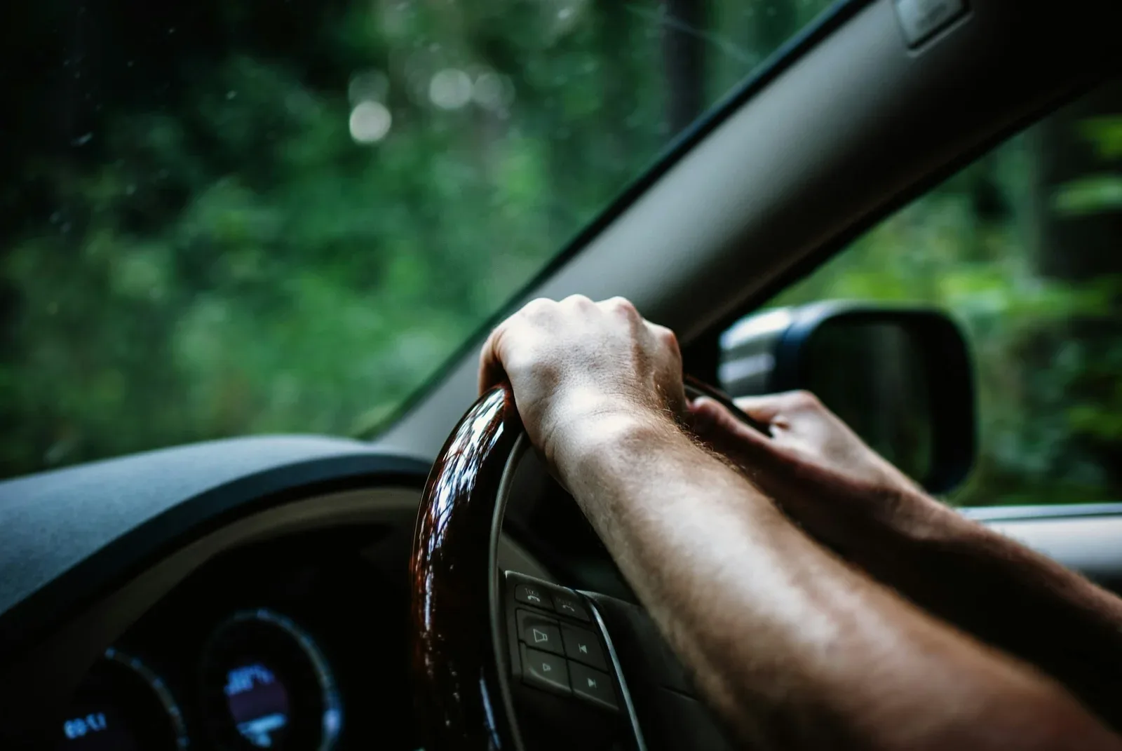 Confident driver with hands on the wheel after defensive driving lessons with DDI